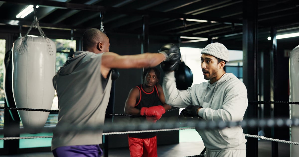 Gym, sports and training with people in boxing ring for fitness, self defense or sparring