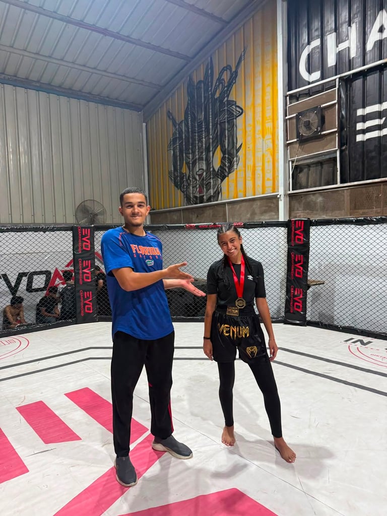 Two people shaking hands inside an MMA octagon cage at a training facility